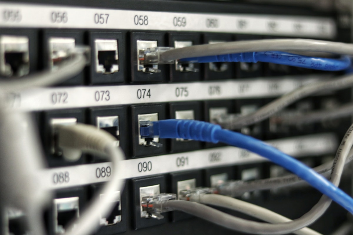 Numbered server patch panel with ethernet cables representing Proxmox VE cluster node connectivity and server infrastructure